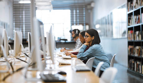 patrons using computers in the library