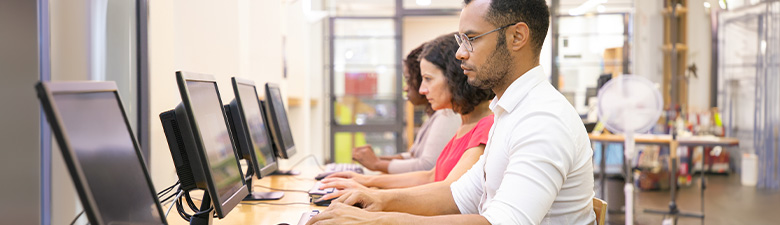 Young adults on computers at library