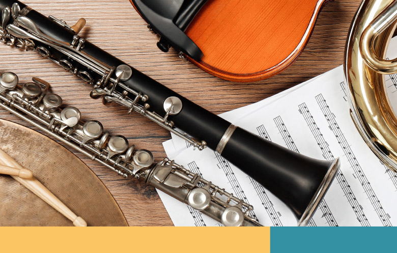 Music instruments on a table with sheet music