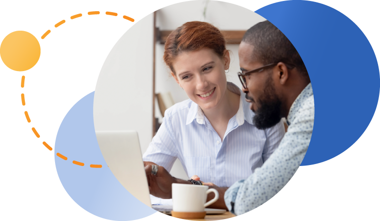 Two employees looking at laptop together and having a conversation